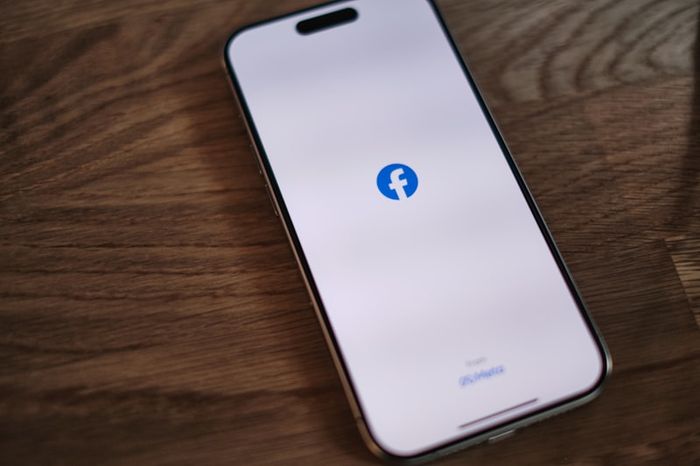 A person using Facebook on their phone with privacy in mind